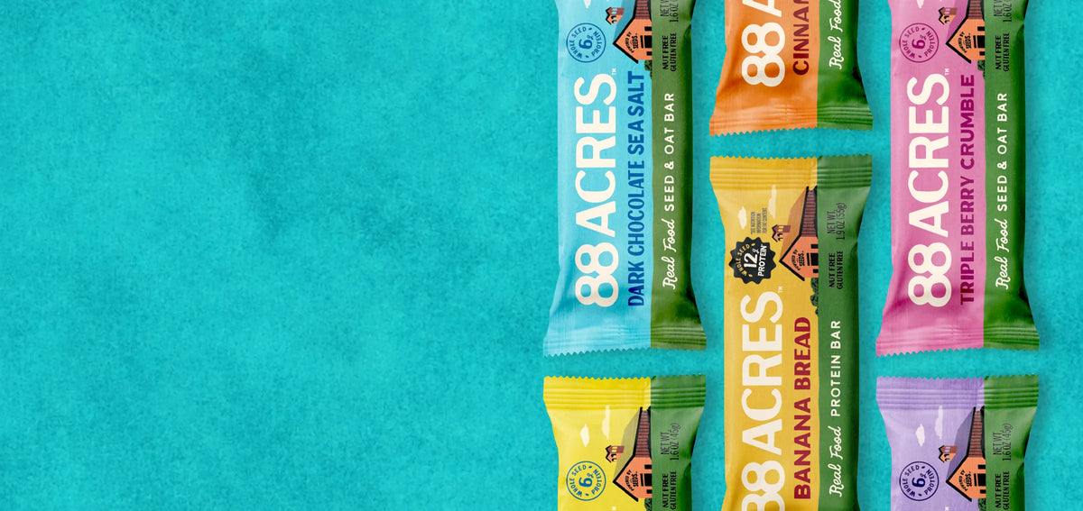 88 Acres Seed + Oat Bars and a Banana Bread Protein Bar on a teal background